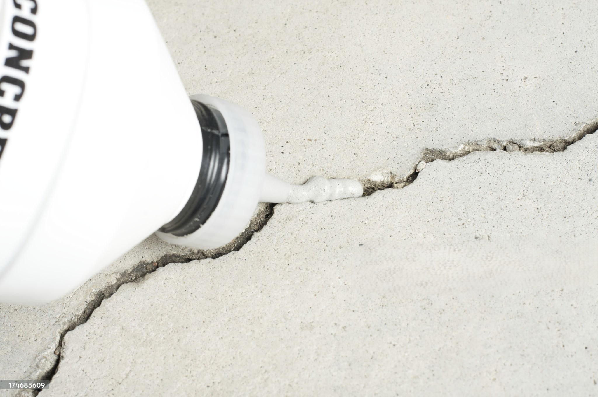 Concrete crack filler being applied to a crack