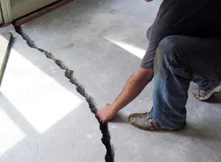 Wide settlement crack in concrete slab