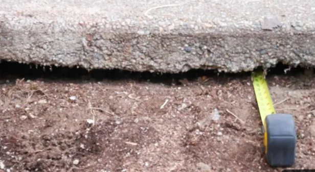Soil erosion and void under a concrete slab edge